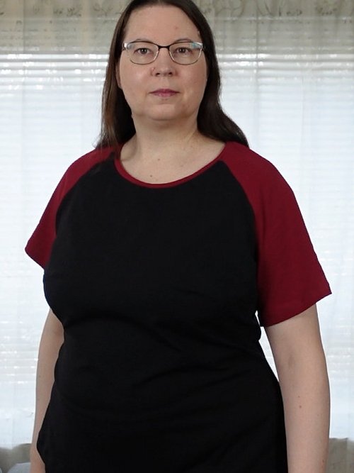 Woman in a black T-shirt with red raglan sleeves